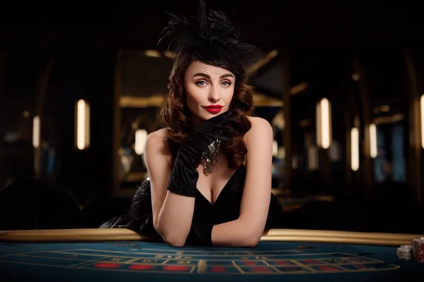 A glamorous woman holding casino chips in a neon-lit environment, representing the premium online casino atmosphere of 4777BET.